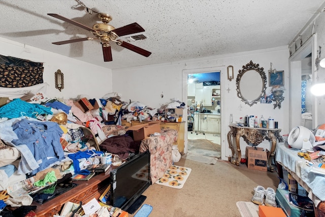 bedroom featuring a textured ceiling, carpet floors, connected bathroom, and ceiling fan