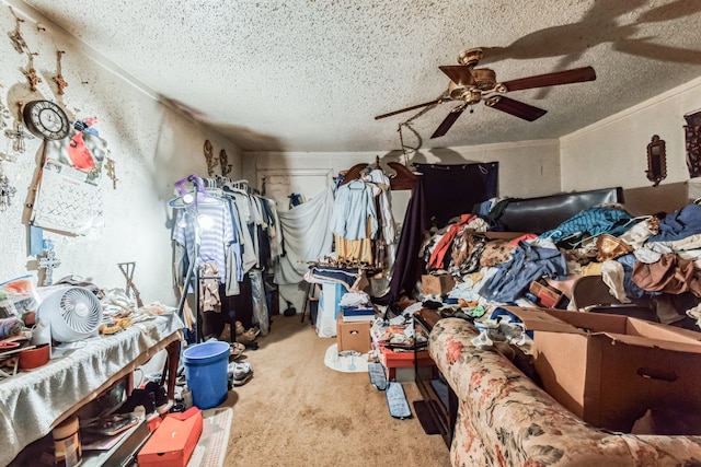 misc room with a textured ceiling, ceiling fan, and light colored carpet