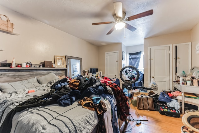 bedroom with ceiling fan and hardwood / wood-style flooring