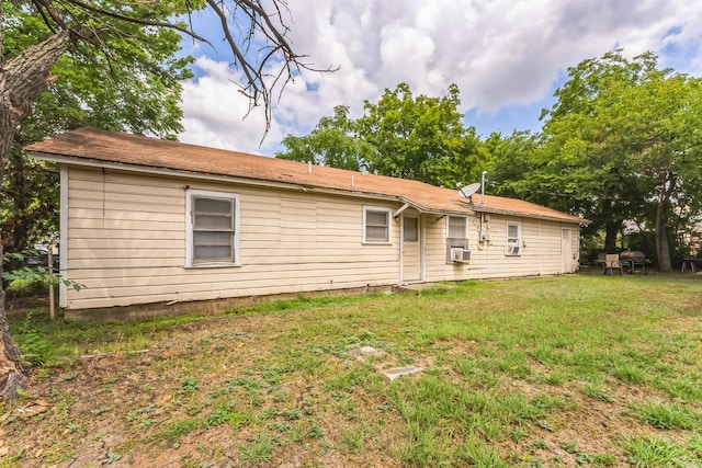 rear view of property with a lawn