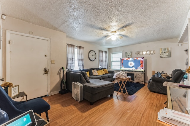 living room featuring a textured ceiling, ceiling fan, and hardwood / wood-style floors