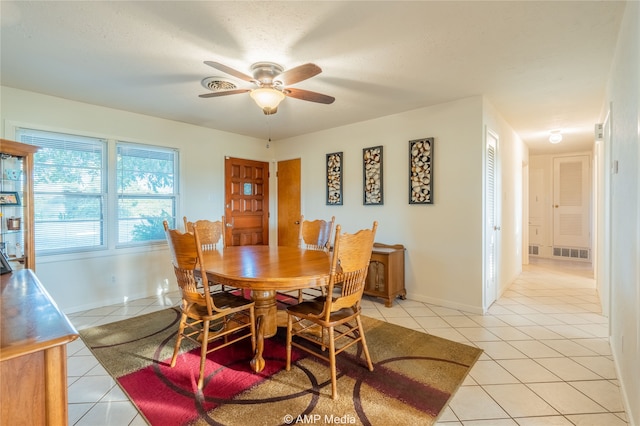 tiled dining room with ceiling fan