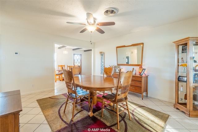 dining area with light tile patterned floors and ceiling fan