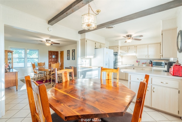 tiled dining area with beam ceiling and ceiling fan with notable chandelier