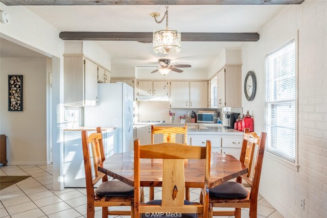 dining space featuring plenty of natural light, ceiling fan with notable chandelier, ornamental molding, and light tile patterned floors