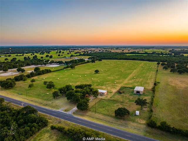 aerial view at dusk featuring a rural view