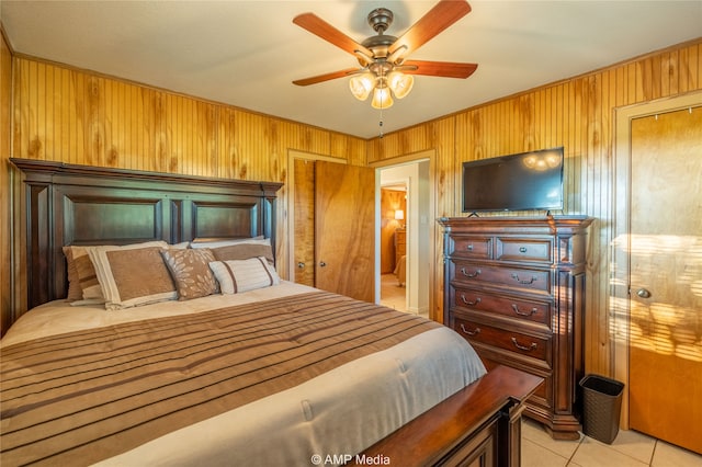 bedroom featuring wooden walls and ceiling fan