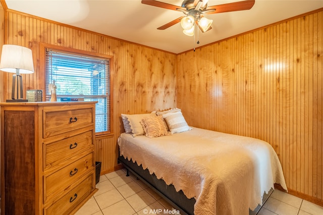 tiled bedroom featuring wood walls and ceiling fan