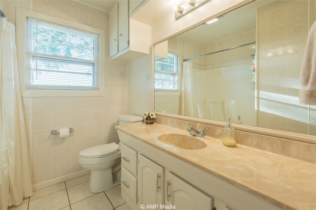 bathroom featuring vanity, tile walls, toilet, and a healthy amount of sunlight