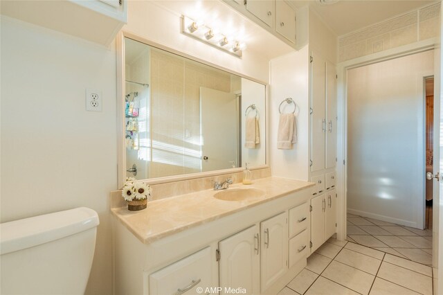 bathroom featuring tile patterned floors, vanity, and toilet