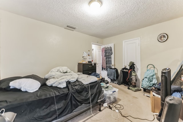 carpeted bedroom with a textured ceiling