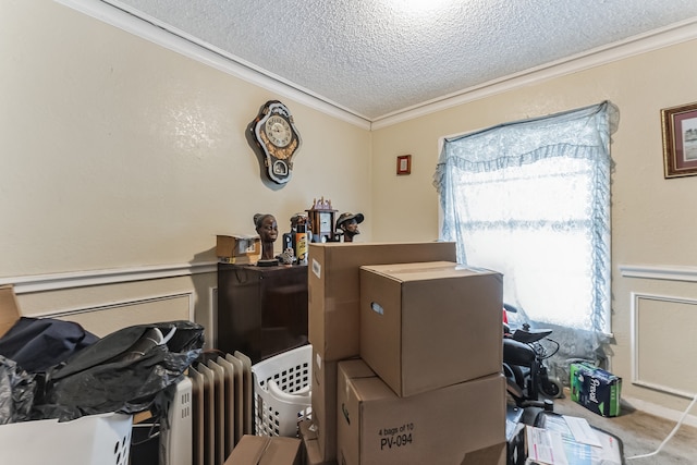 interior space with radiator, a textured ceiling, and ornamental molding