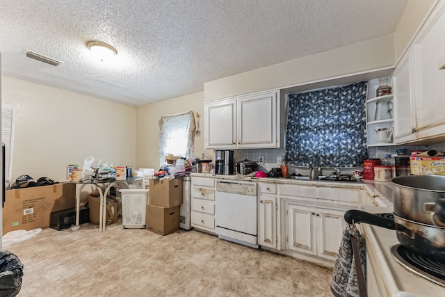 kitchen featuring sink, backsplash, light tile patterned floors, a textured ceiling, and dishwasher