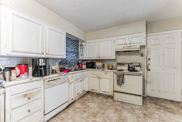 kitchen with white cabinetry, white appliances, light tile patterned floors, a textured ceiling, and decorative backsplash