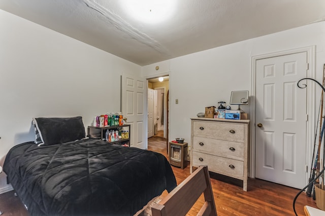 bedroom with dark hardwood / wood-style floors