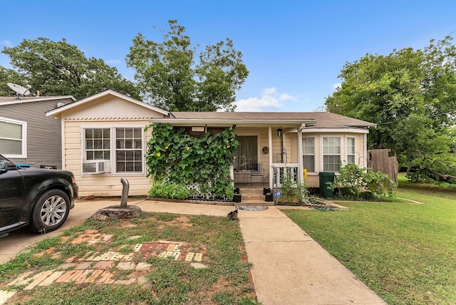 view of front of home with a porch and a front yard