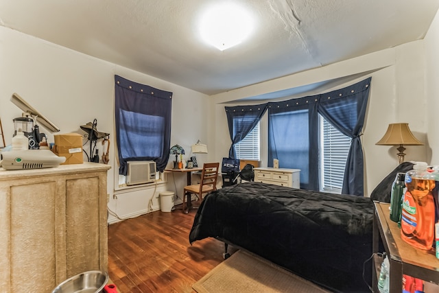 bedroom featuring cooling unit and dark wood-type flooring