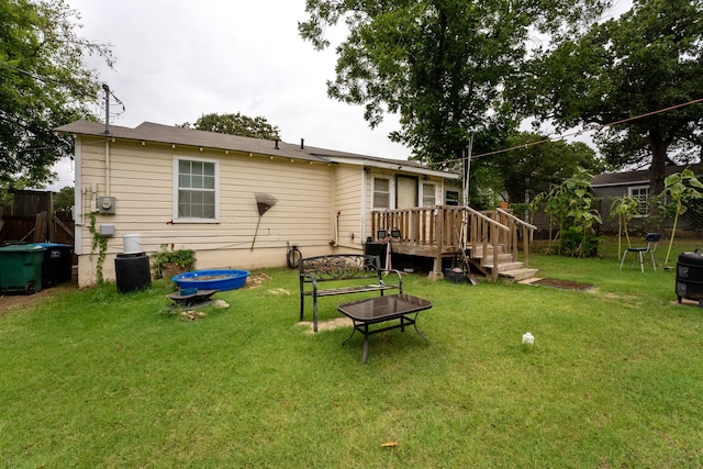 rear view of house featuring a yard