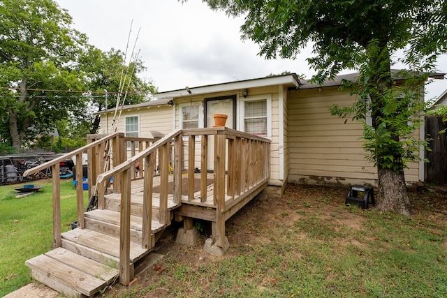 view of front of home featuring a deck and a front yard