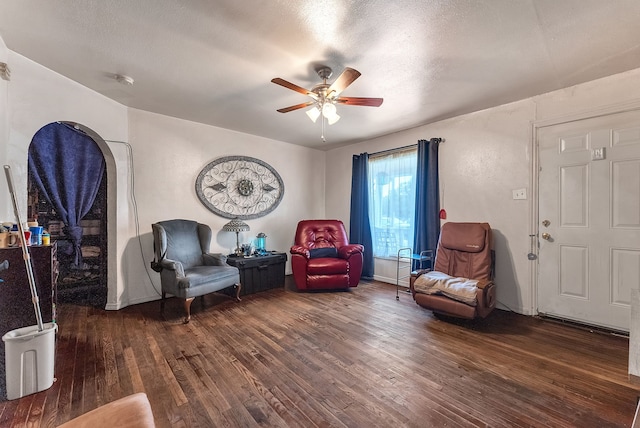 sitting room with a textured ceiling, ceiling fan, and wood-type flooring