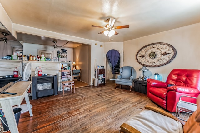 living room featuring wood-type flooring and ceiling fan