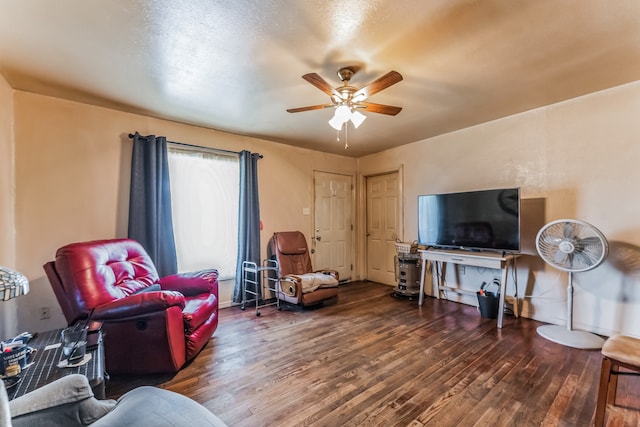 living room featuring wood-type flooring and ceiling fan