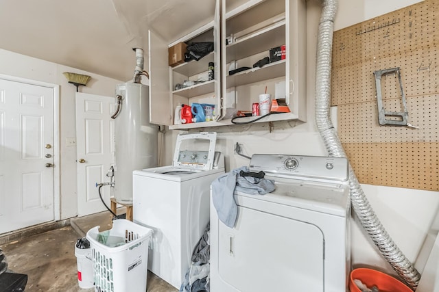 clothes washing area featuring gas water heater and washing machine and dryer