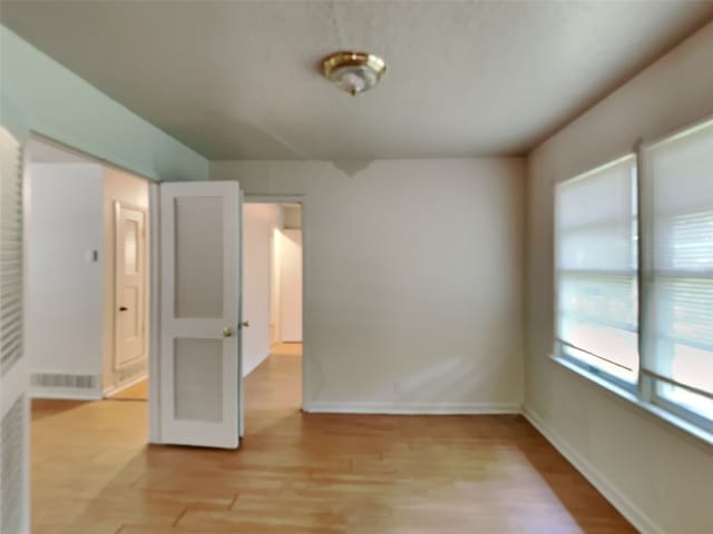 empty room with light hardwood / wood-style floors