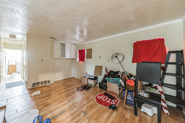 interior space featuring crown molding and light wood-type flooring