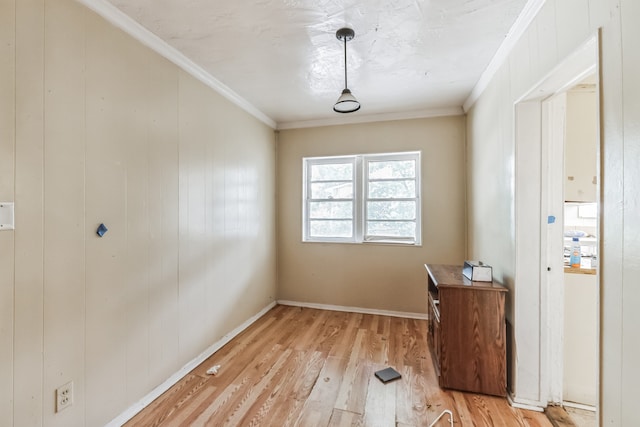 interior space with crown molding and light hardwood / wood-style flooring