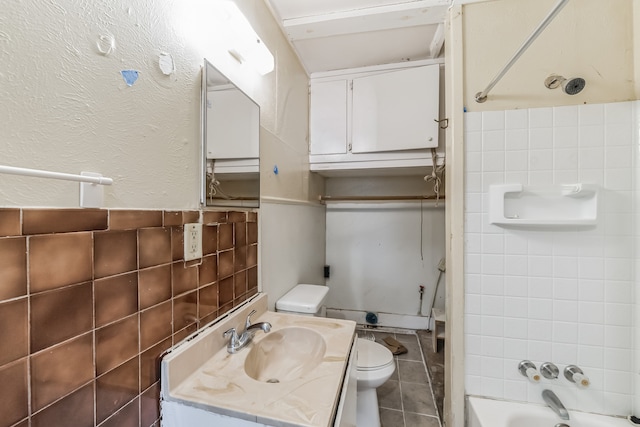 full bathroom with tile patterned flooring, tile walls, shower / bath combination, and toilet