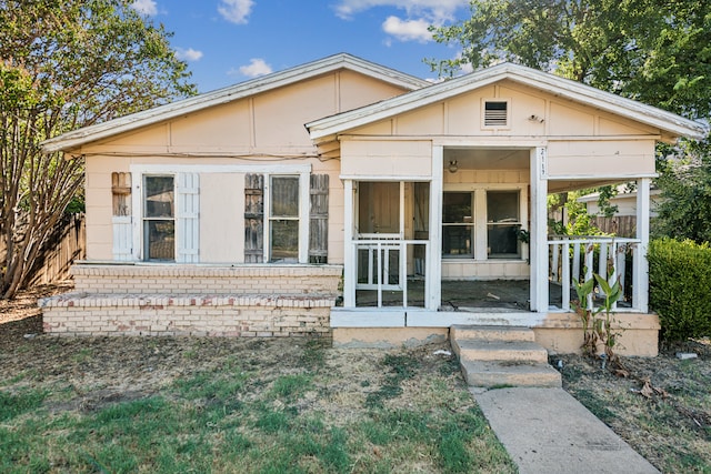 rear view of house with covered porch