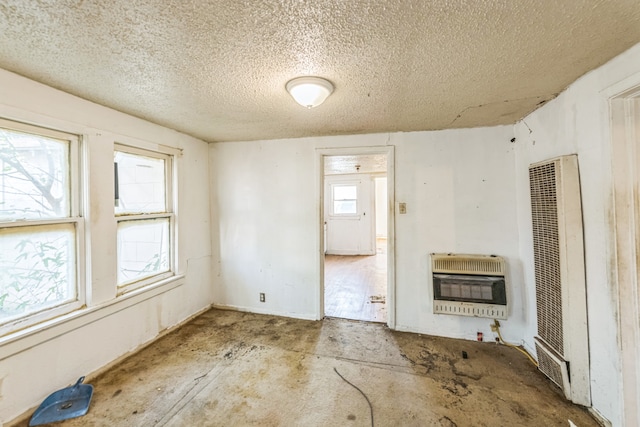 unfurnished living room with a textured ceiling and heating unit