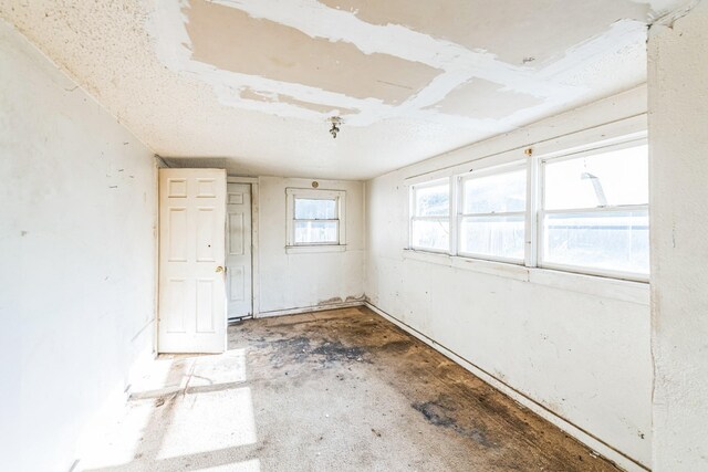 unfurnished room featuring concrete floors