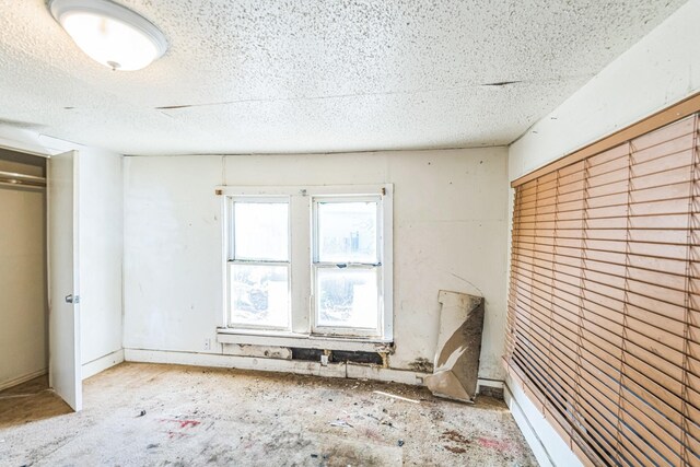 unfurnished bedroom featuring a closet and a textured ceiling