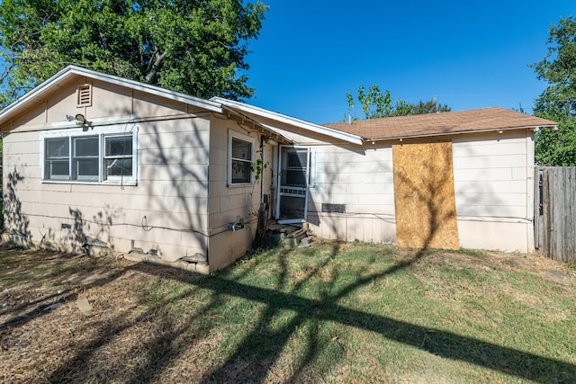 rear view of house with a lawn