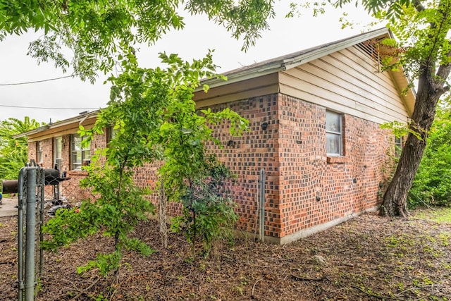 view of side of home featuring brick siding