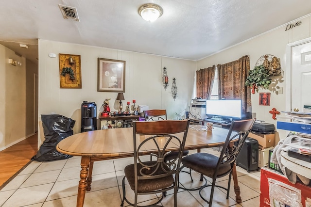 dining area featuring visible vents and light tile patterned flooring