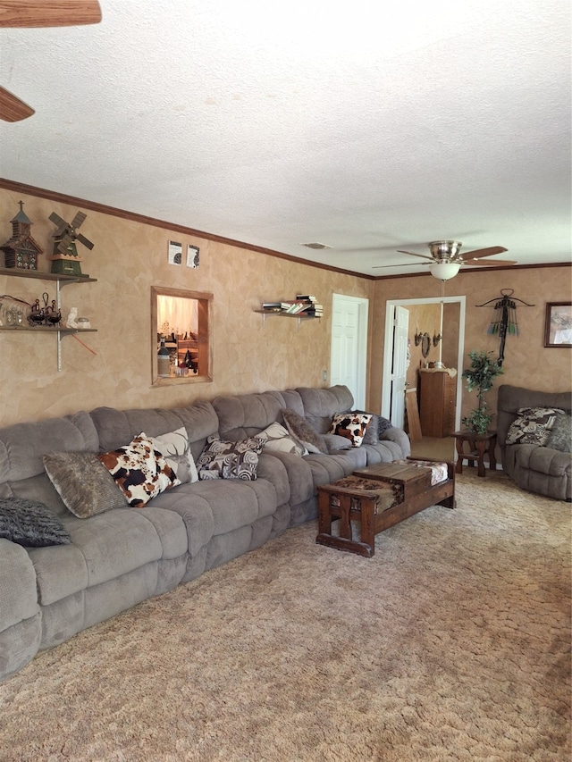 carpeted living room with ceiling fan, ornamental molding, and a textured ceiling