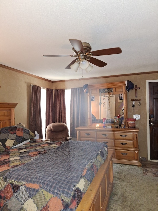 carpeted bedroom featuring crown molding and ceiling fan