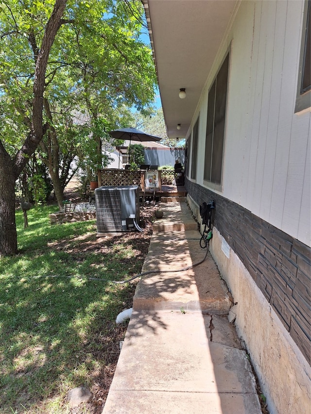 view of yard with cooling unit and a patio