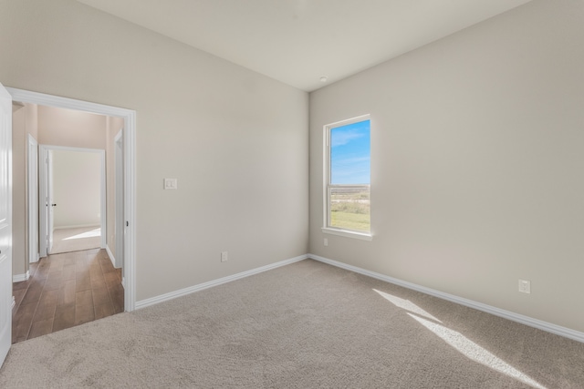 unfurnished room with wood-type flooring