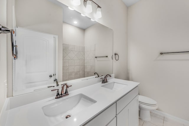 bathroom featuring vanity, toilet, and tile patterned floors