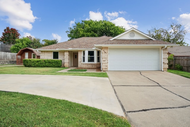 ranch-style home featuring a garage and a front yard