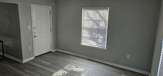 spare room featuring dark carpet