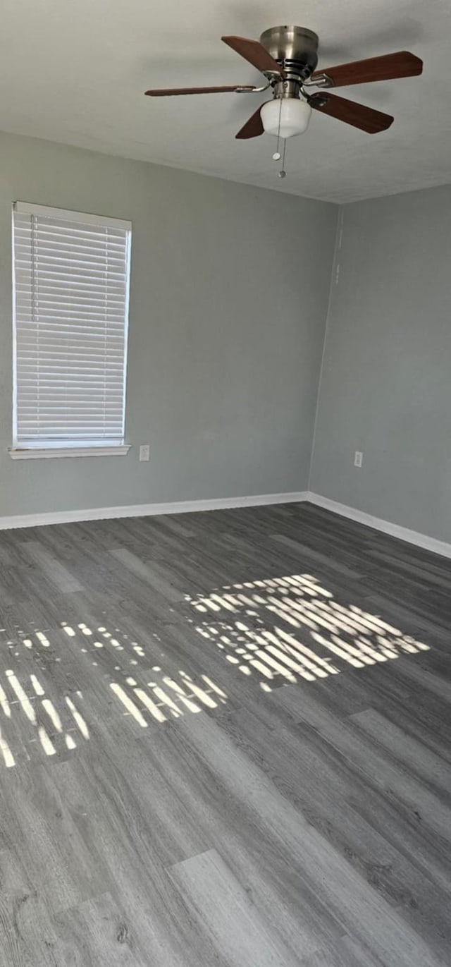 unfurnished bedroom featuring ceiling fan, a closet, and dark carpet