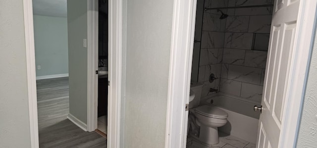 full bathroom featuring toilet, vanity, and tiled shower / bath