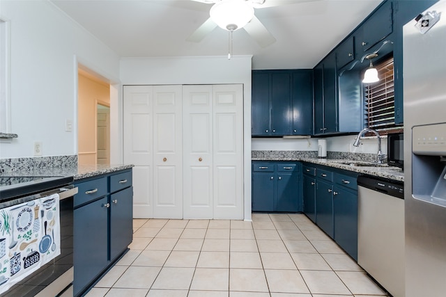 kitchen with sink, ceiling fan, stainless steel appliances, and blue cabinetry