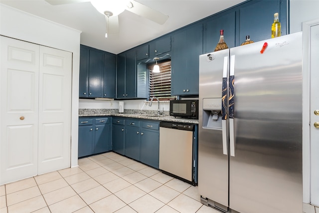 kitchen with light tile patterned floors, ceiling fan, stainless steel appliances, blue cabinets, and ornamental molding