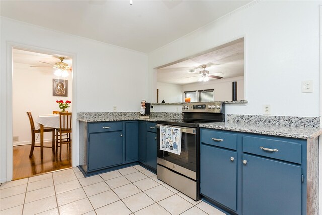 kitchen with stainless steel electric range, light tile patterned flooring, ceiling fan, and blue cabinets